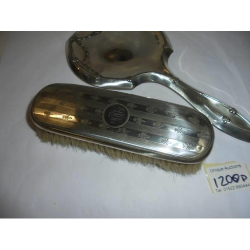 1200D - A good hall marked silver hand mirror and a silver backed hair brush.