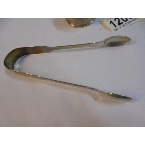 1208 - A pair of mid 20th century silver sugar tongs and a silver napkin ring.