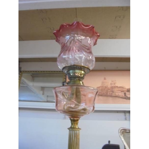 1215 - A good old oil lamp complete with Victorian cranberry edged shade. COLLECT ONLY.