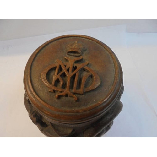 1229 - A Chinese carved wood tobacco jar, the lid having a regimental/royal crest.