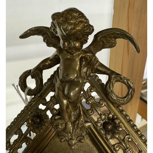 1131 - A brass diamond shaped cherub surmounted clock, circa 1900 by William Tonks, 21.5 cm tall.