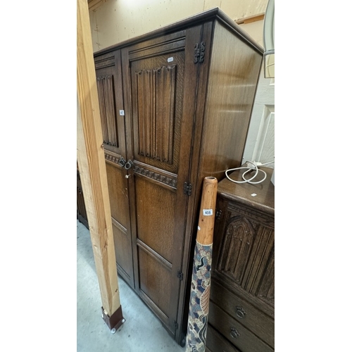 407 - An oak 2 door wardrobe with linen fold decoration. COLLECT ONLY.