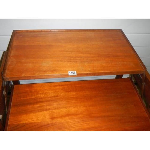 1568 - A teak metamorphic table, COLLECT ONLY.