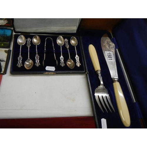 1581 - A set of silver spoons and a pair of fish servers.