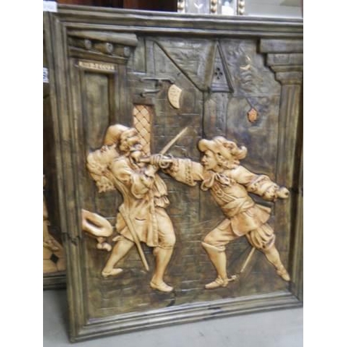 1590 - A pair of unusual plaster wall plaques featuring the fighting of a duel, COLLECT ONLY.