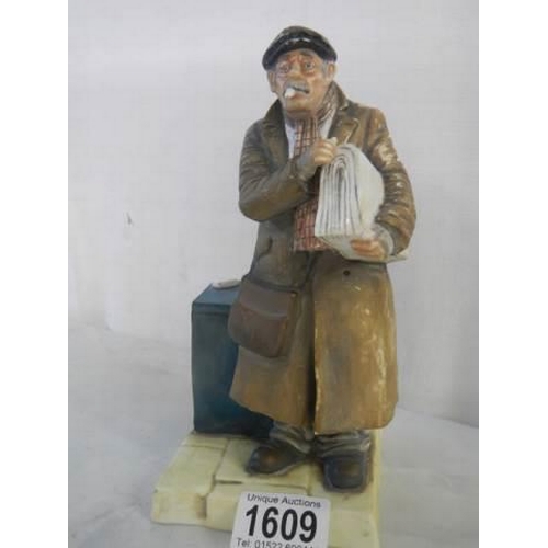 1609 - A good figure of a newspaper seller, 20 cm. in good condition.