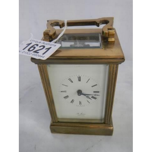 1621 - A St. James brass carriage clock in working order (slight crack in rear door).