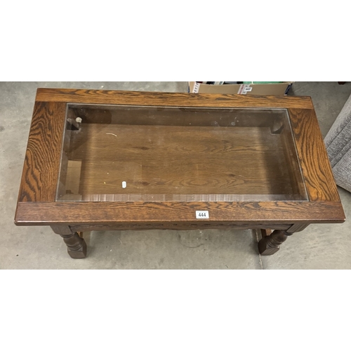 444 - An unusual dark oak coffee table with display cabinet top. 51cm x 100cm x 47cm high with bevelled gl... 