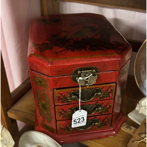 523 - A good quality Japanese style red lacquered jewellery casket.