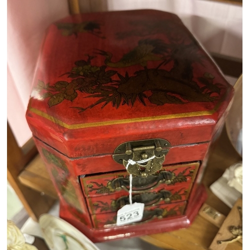 523 - A good quality Japanese style red lacquered jewellery casket.