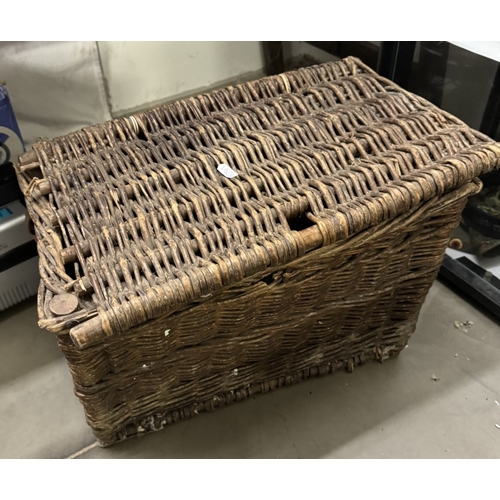 554 - A wicker fishing basket & contents including Alcocks Argus reel etc.