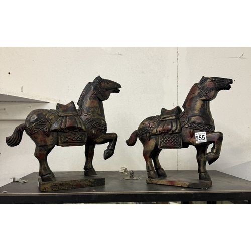 555 - A pair of wooden Tang horses