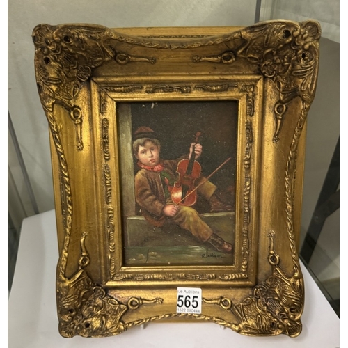 565 - A gilt framed enhanced print of a boy with violin (over painted)