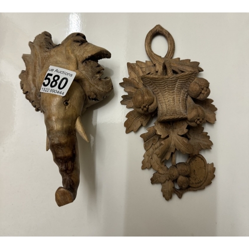 580 - 2 unusual wood carvings one being an elephant head.