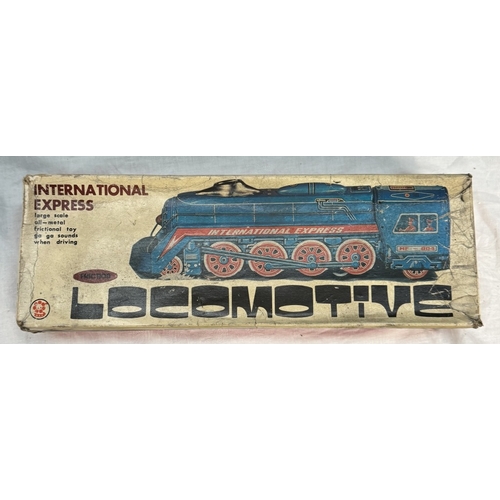 866 - A boxed international express locomotive, Paya clockwork tinplate bus & A large Mettoy tin lithograp... 