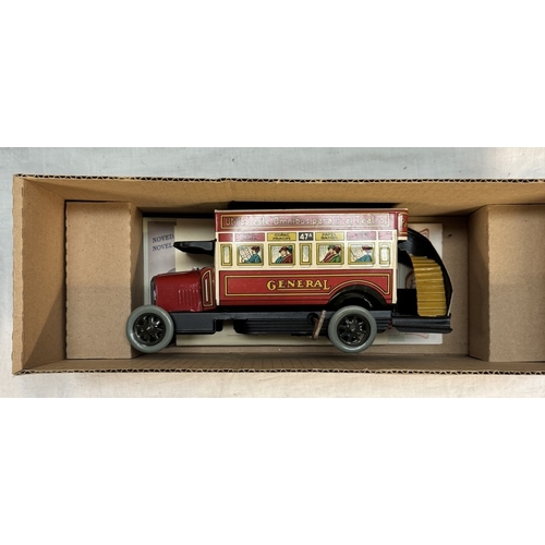 866 - A boxed international express locomotive, Paya clockwork tinplate bus & A large Mettoy tin lithograp... 