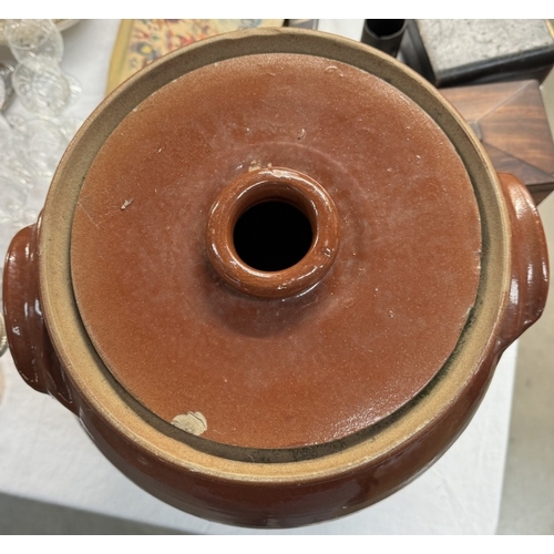 1078 - A large part glazed stoneware lidded jar. Height 40cm