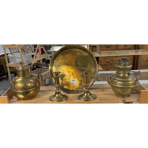 1082 - A brass Army & Navy CSL makers London lidded pot, A pair of candlesticks, oil lamp & tray