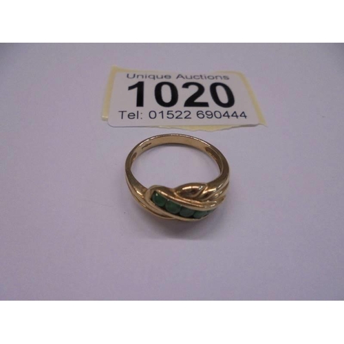 1020 - A 9ct yellow gold emerald and diamond ring, size P, 2.6 grams.