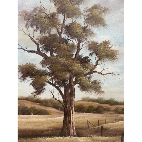 987 - A gilded framed oil on canvas, tall tree in field