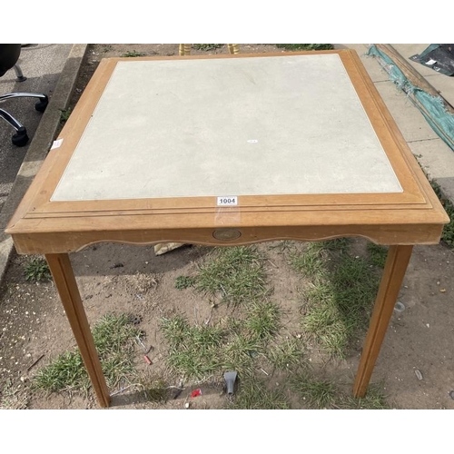 1004 - A wooden folding table with leather top