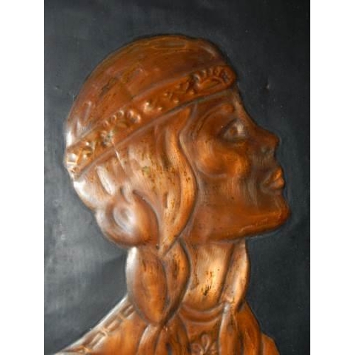 616 - A hammered copper plaque featuring a native American Indian Squaw.