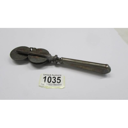 1035 - An antique knife sharpener (handle may be silver).