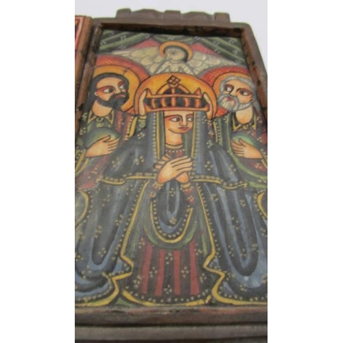 1036 - An antique hand painted icon in carved wood case (possibly Russian).