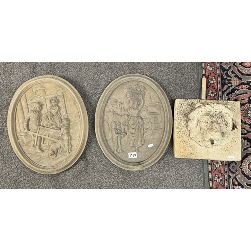 1189 - A pair of oval cement wall plaques and a lion head wall water feature