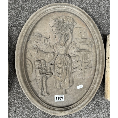 1189 - A pair of oval cement wall plaques and a lion head wall water feature