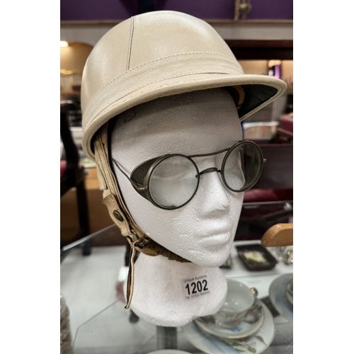 1202 - A vintage motorcycle corker helmet with goggles