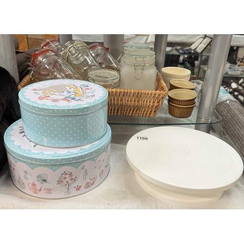 1100 - A quantity of Alice In Wonderland cake tins, Betterware Lazy Susan cake plate, glass jars etc