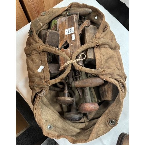 1226 - A vintage carpenters bag of antique tools including Moulding planes, braces, drills etc