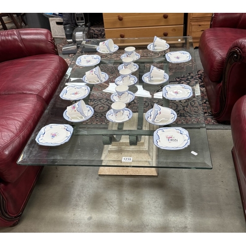 1235 - A glass top coffee table