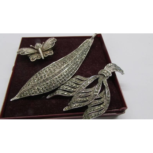 1046 - A silver butterfly brooch together with two vintage marcasite brooches.