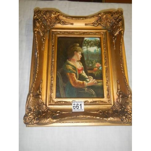 661 - A gilt framed over painted print of a young lady. 30 x 25 cm.