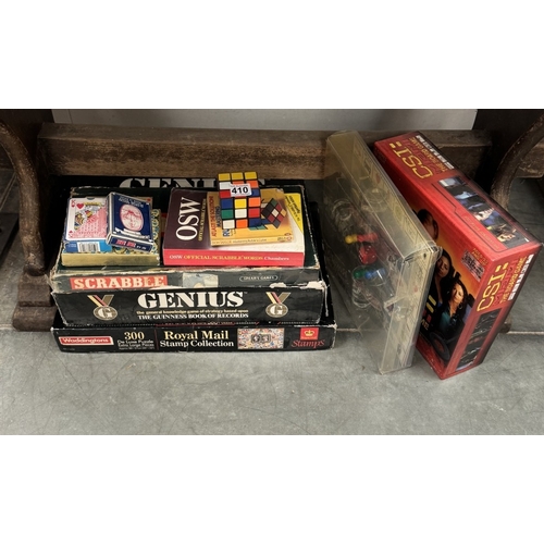 410 - A quantity of board games including Jigsaw, Rubiks cube etc