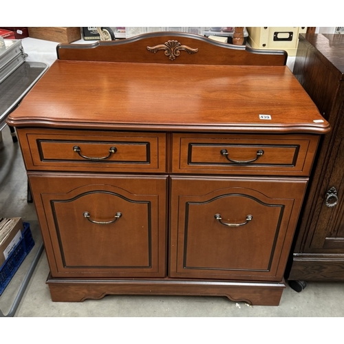 439 - A mahogany effect two door cabinet. COLLECT ONLY.