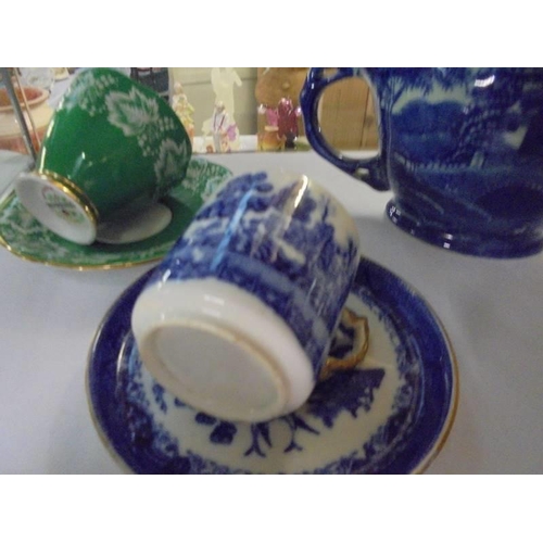 525 - Two shaving mugs and three tea cups and saucers.