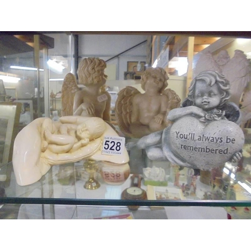 528 - Four assorted cherub figures.