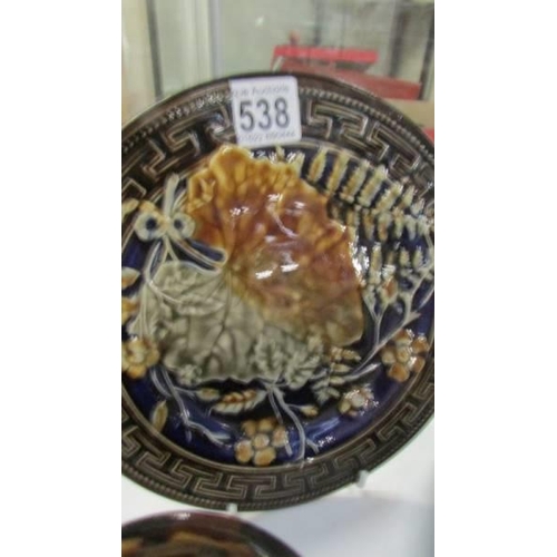 538 - An early Majolica plate and a stoneware tobacco jar.