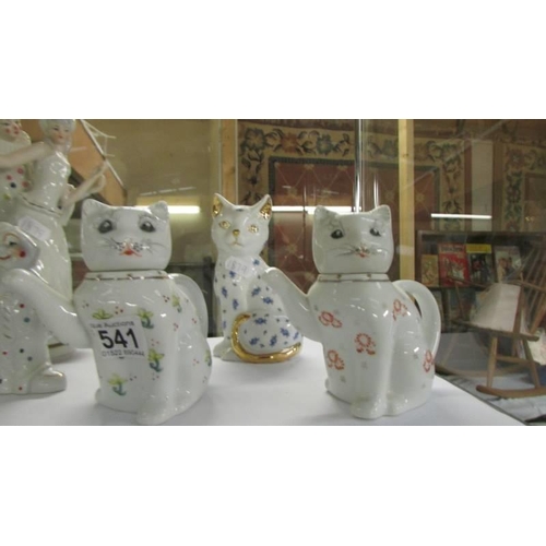 541 - A cat, two cat teapots and three clown figures including a musical example.