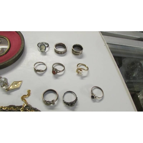 560 - Nine rings, other jewellery &  A modern framed miniature portrait.