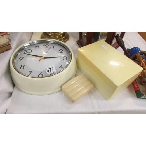 577 - A vintage wall clock (working), a soap boax and another plastic box.