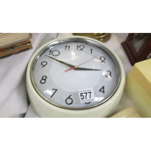 577 - A vintage wall clock (working), a soap boax and another plastic box.