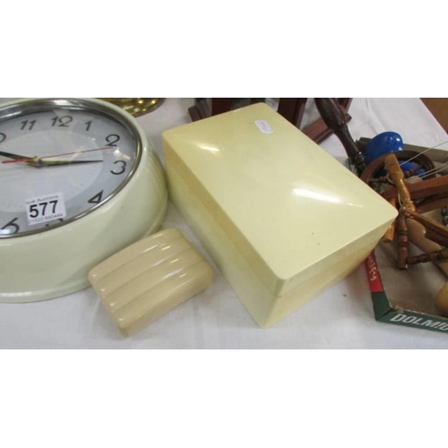 577 - A vintage wall clock (working), a soap boax and another plastic box.