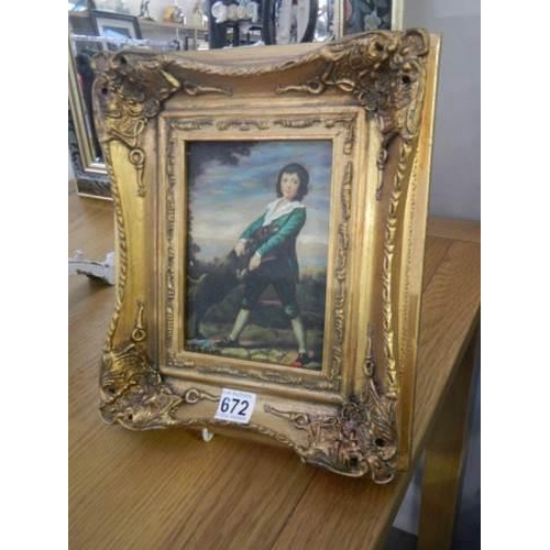 672 - A gilt framed overpainted print of a boy with a dog.