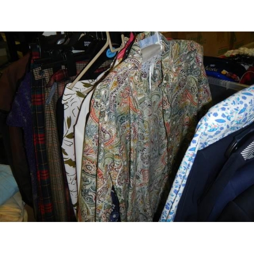 678 - A clothes rack of ladies and gents garments,.