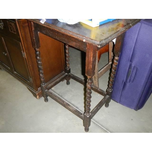 692 - A Oak occasional table with barley twist supports,. COLLECT ONLY.