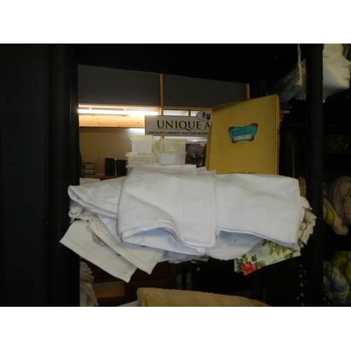 696 - Five shelves of towels, linen, cushions etc.,